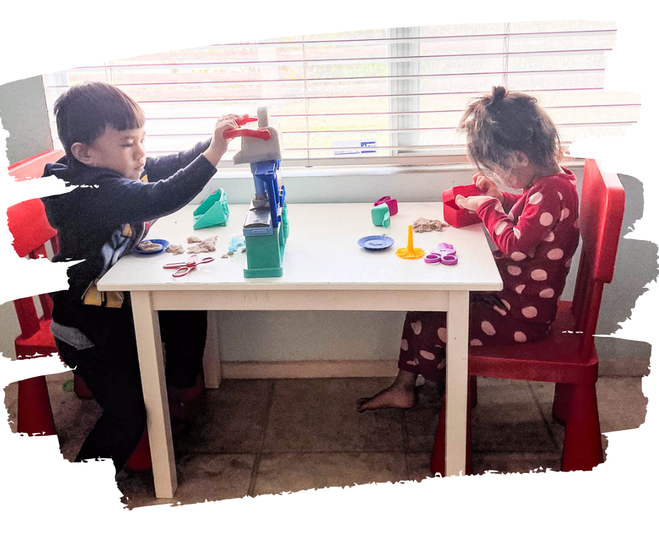 2 kids playing on a table